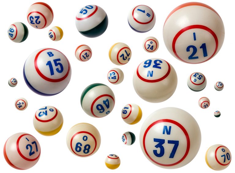 Flying Bingo balls with assorted numbers in white background